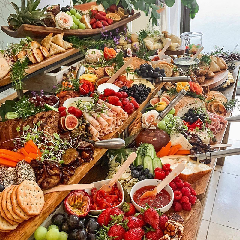 Harvest table grazing board with cheeses, fruit and dips